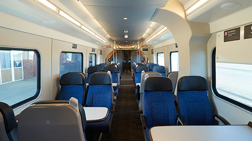 Picture inside the Te Huia train showing seats and tables